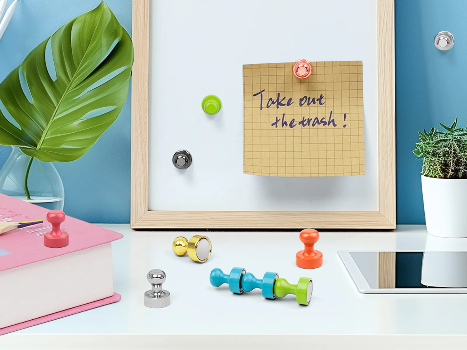 Colorful compact magnetic push pins displayed on a whiteboard and desk